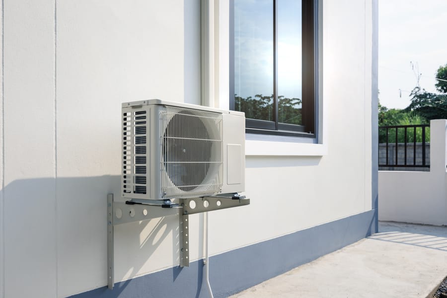 Ductless mini-split unit on the side of house.