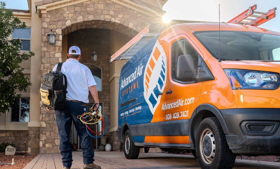 Advanced Air Systems van with plumber walking in with tools.