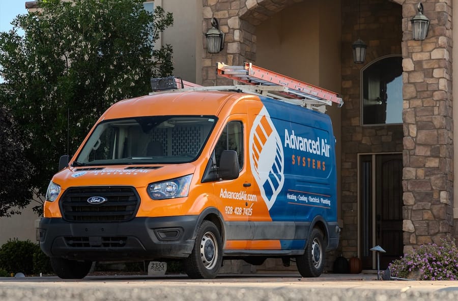 Advanced Air van in driveway outside of house.