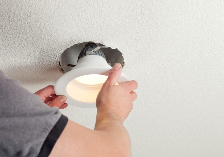 Installing a light in the ceiling.