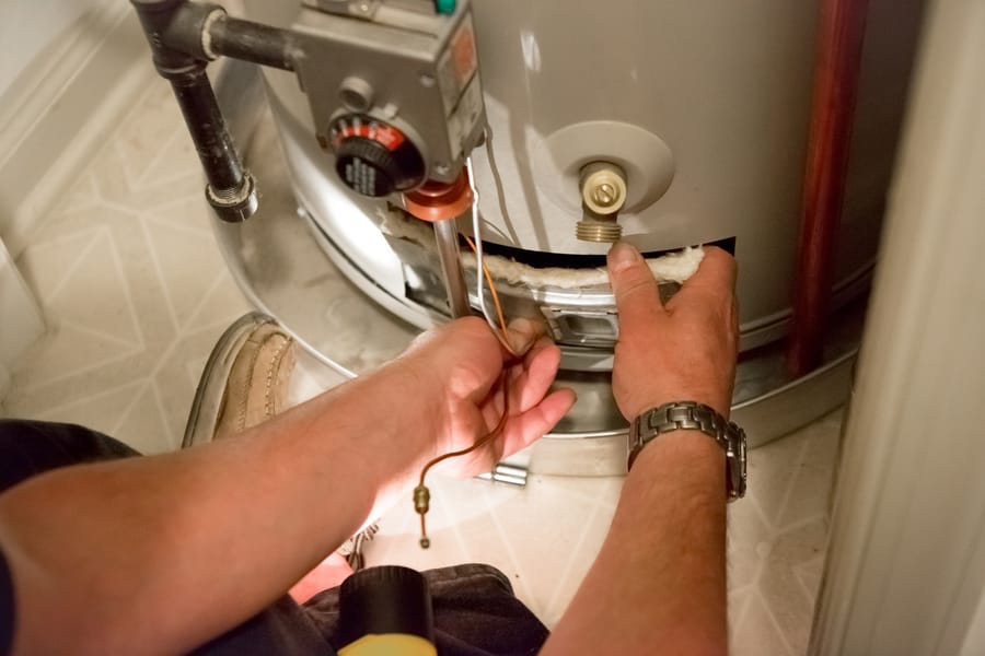 Plumber conducting heater repair.
