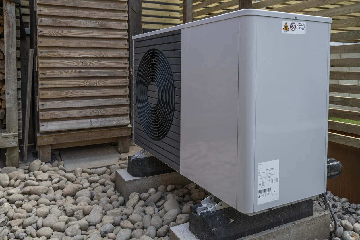 Modern high-efficiency heat pump outside of a home