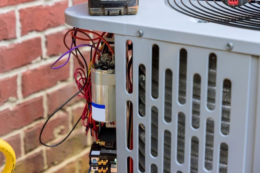 Outdoor air conditioning unit that is being repaired. The wiring in the back is visible.